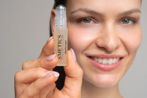 Frau mit anti-pickel-roll-on-stift in der rechten Hand.